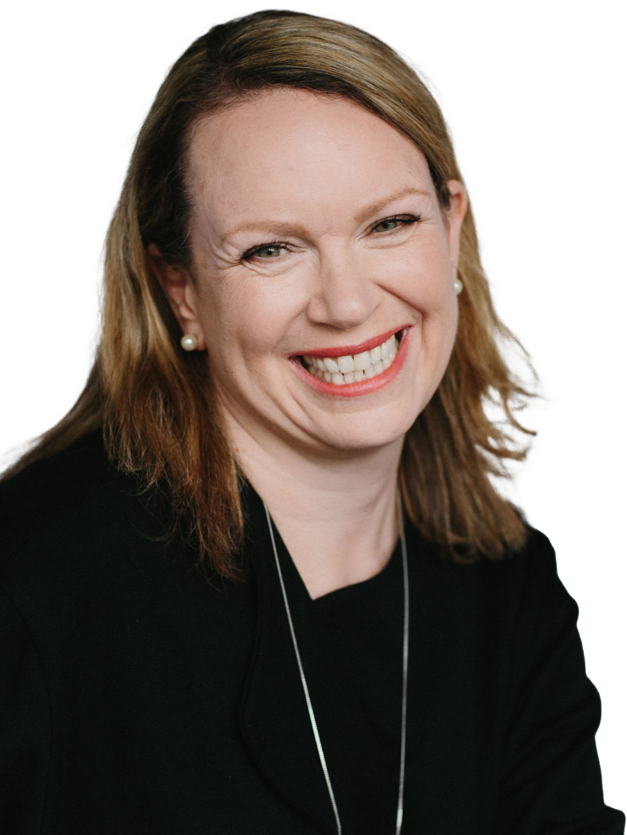 A woman named Ruth is smiling brightly, wearing a black top, pearl earrings, and a necklace. She has light brown hair parted to the side and is looking directly at the camera.